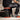 Avit Collapsible Stool AV00010 being sat on while a worker is attaching pipe clips to a wall.