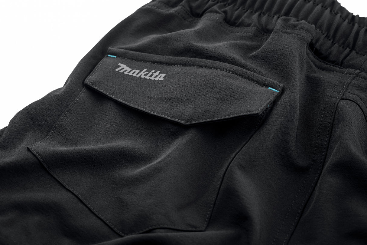 Close up of the Makita Axis Stretch Shorts in black showing the Makita logo on the rear pocket.