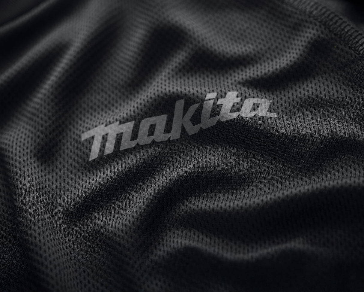 Close-up of Makita logo on a black Makita tech t shirt.