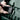 Image showing the Metabo GPS Tracker being screwed into the lid of a metabo metaloc case. A hand can be seen holding the tracker, while a screwdriver is tightening the screws. It is being attached to a green metabo metaloc case.