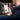 Image showing an iphone being held in a hand. On the screen we can see the Metabo app with tracking information shown. In the background are rows of metabo tools in metaloc boxes.