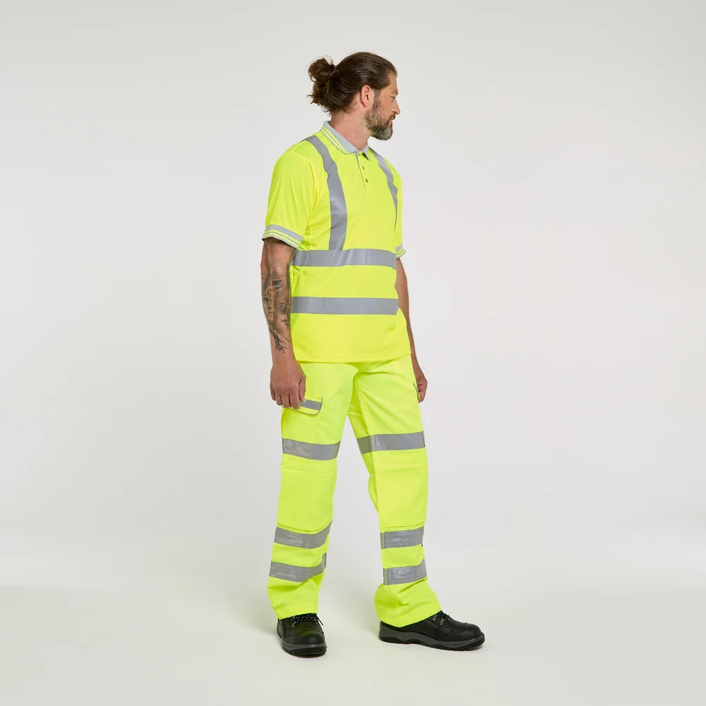 Person wearing a bright yellow high-visibility work outfit on a white background