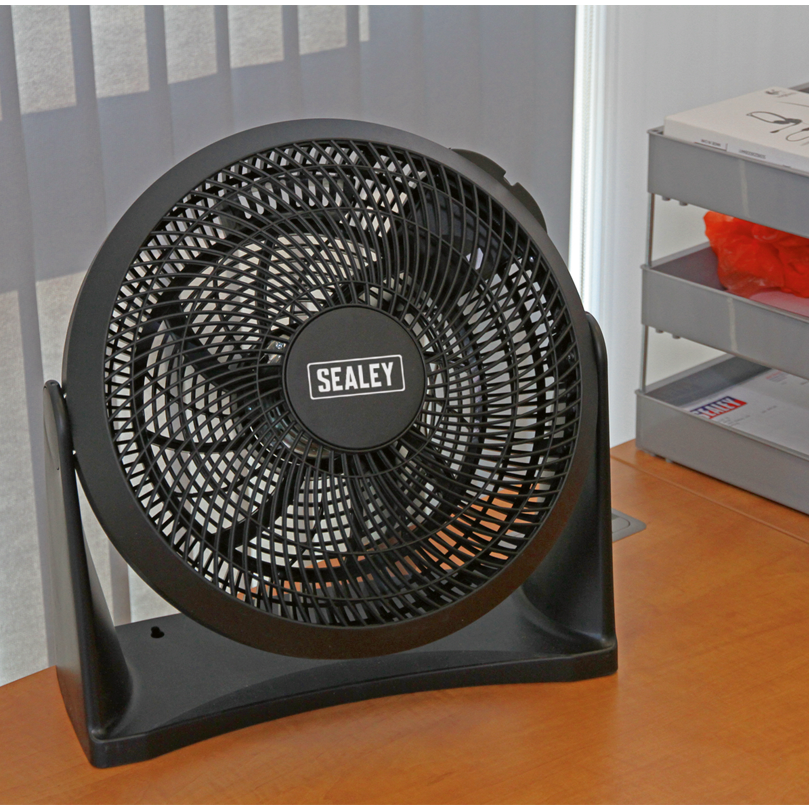 Black Sealey fan on a wooden surface with a striped wall in the background