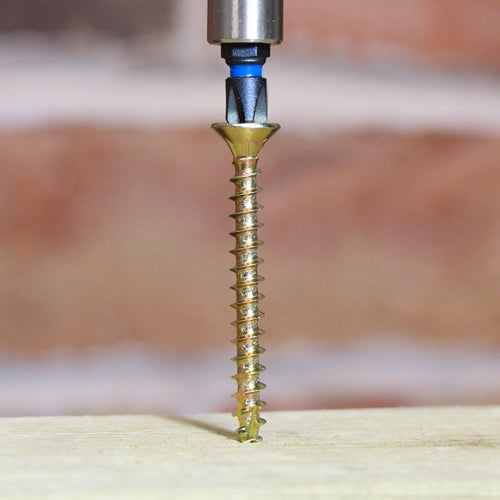 A Timco C2 structural wood screw driving cleanly into a piece of timber, creating a flush finish without splitting the wood.