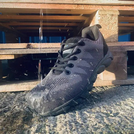 Rock fall Atlanta safety trainer demonstrating the waterproof feature by having water poured over the toe.