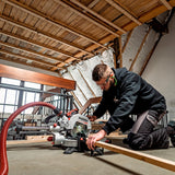 Metabo KGS 18 LTX BL 216 crosscut mitre saw 614216850 shown cutting timber in a loft area.