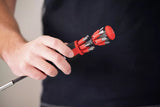 Person holding a red and black Wiha screwdriver with multiple components against a dark background