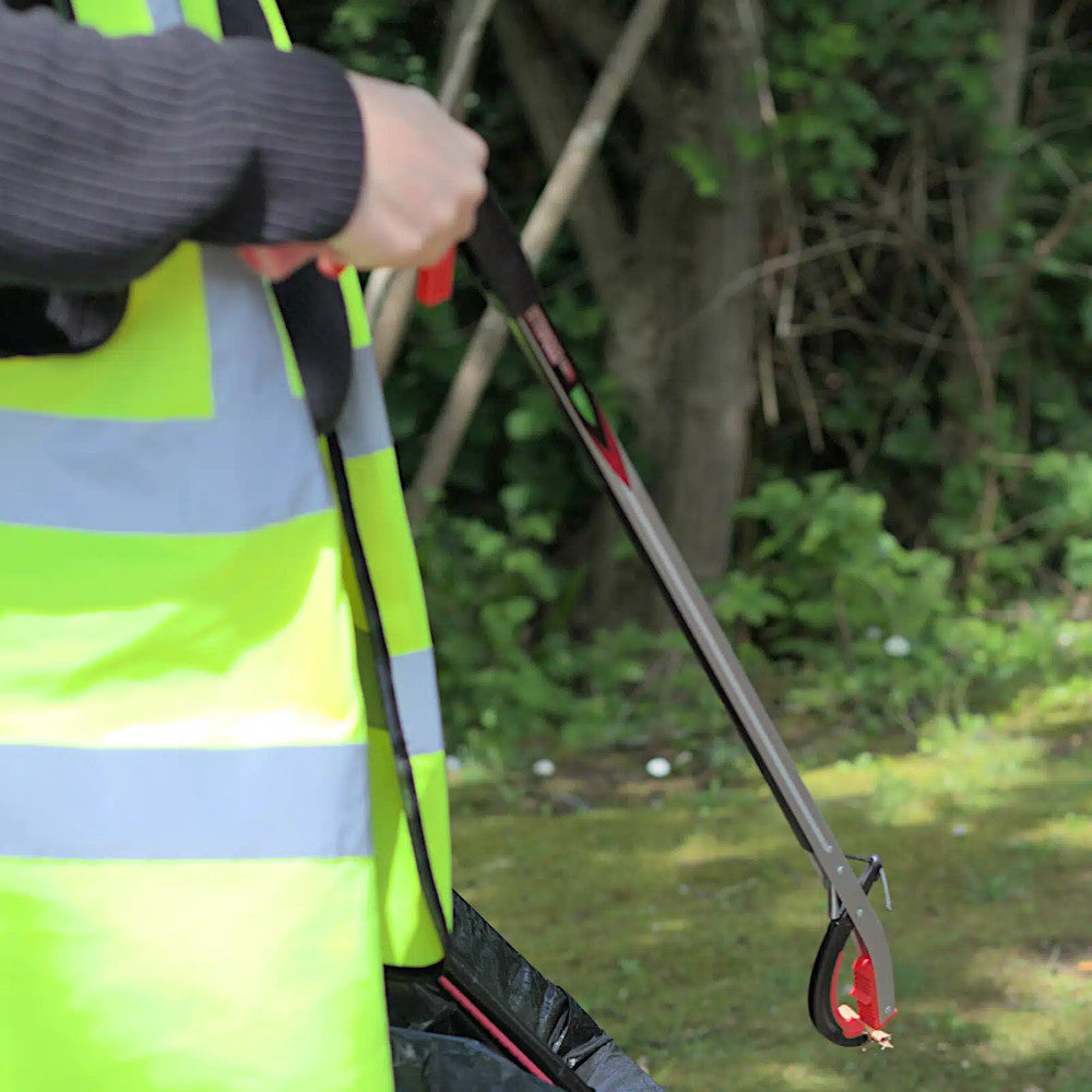 image showing the Helping Hands Litter Picker PRO Litter Grabber being used to collect litter