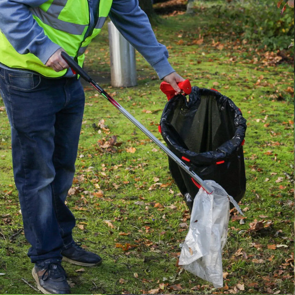 Helping Hands Litter Picker PRO Litter Grabber 33″/ 85cm being shown grabbing a plastic bag ready to be put in a bin bag.