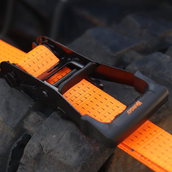 Kargo 8m ultra duty orange ratchet strap on a tire with 'Kargo' branding.