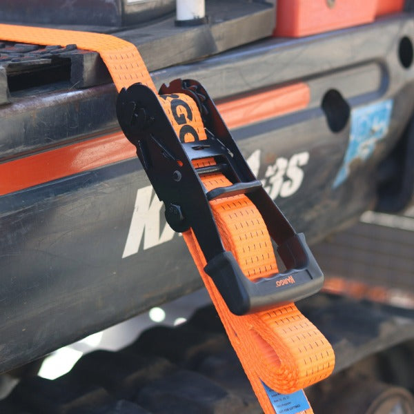 Kargo 8m ultra duty orange ratchet strap with a black clip attached to a vehicle, with 'KTM' branding visible.