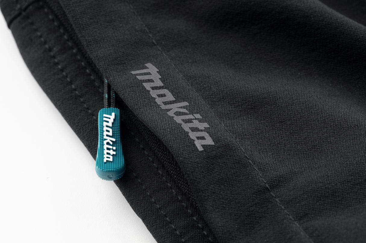 Close-up of the Makita Axis Stretch Shorts in black with a visible Makita logo on a white background