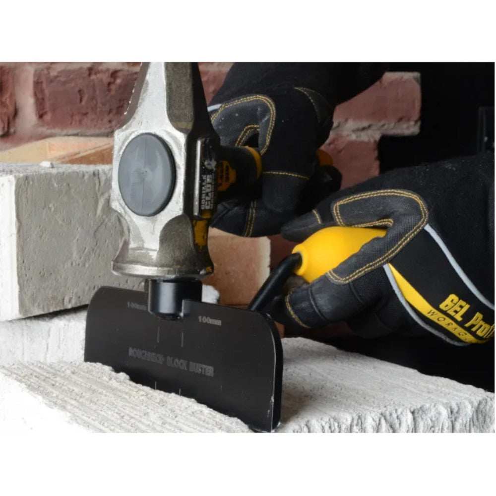 The Roughneck Gorilla Block Buster Bolster, a hand tool for cutting blocks and bricks. Shown in use cutting through a block.