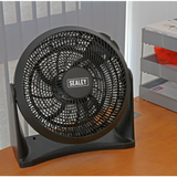 Black Sealey fan on a wooden surface with a striped wall in the background