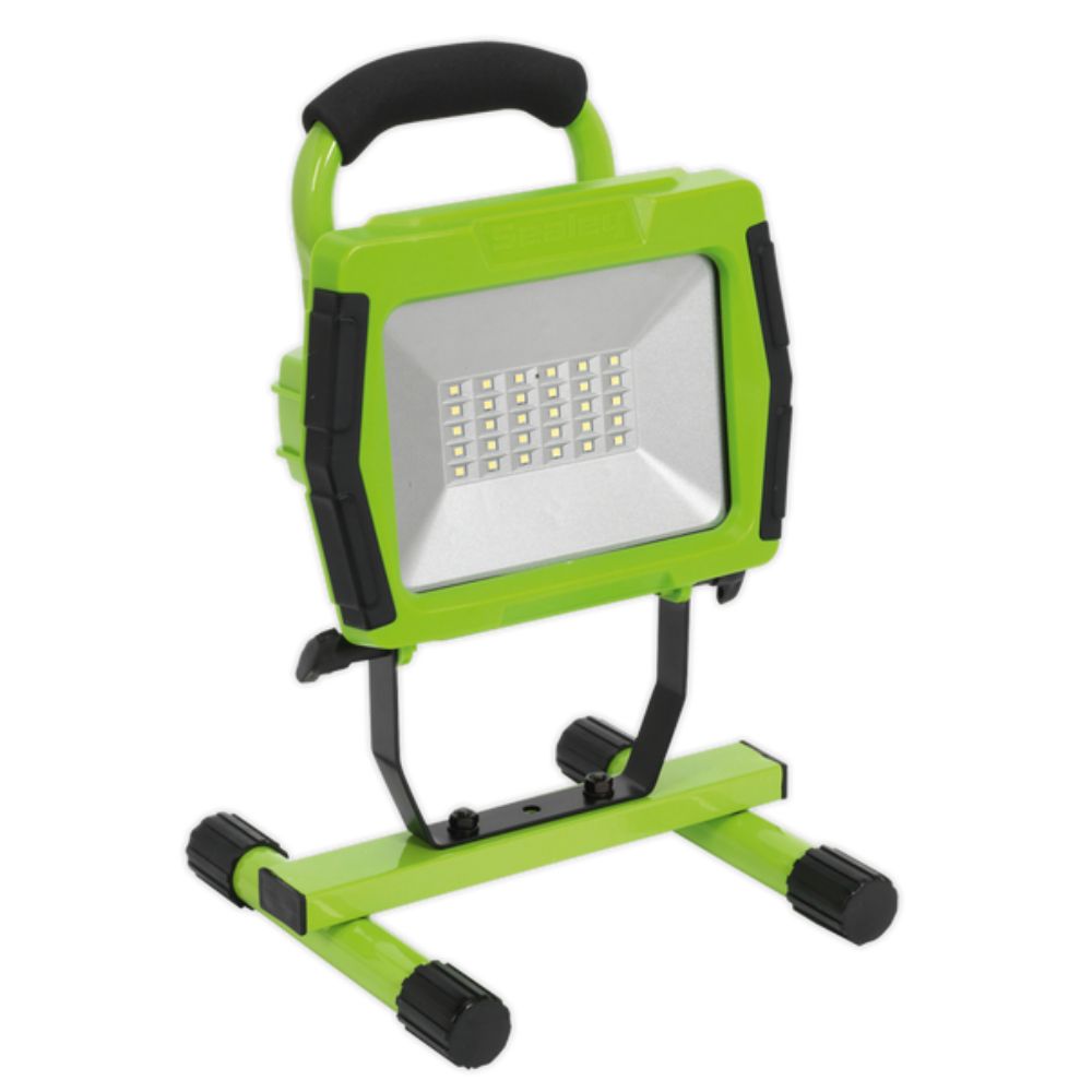 Green and black portable work light on a white background