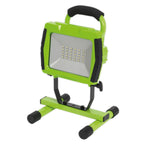 Green and black portable work light on a white background