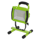 Green and black portable work light on a white background