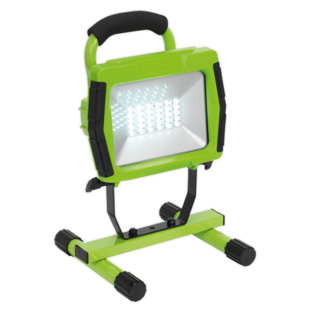 Green and black portable work light on a white background