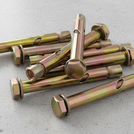 Metal zinc plated sleeve anchors on a concrete floor.