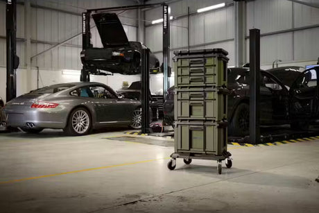 Stack of bunker load up drawer storage on wheels in a garage with cars and equipment in the background