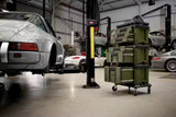 Automotive repair shop with cars on lifts and storage bins in the foreground