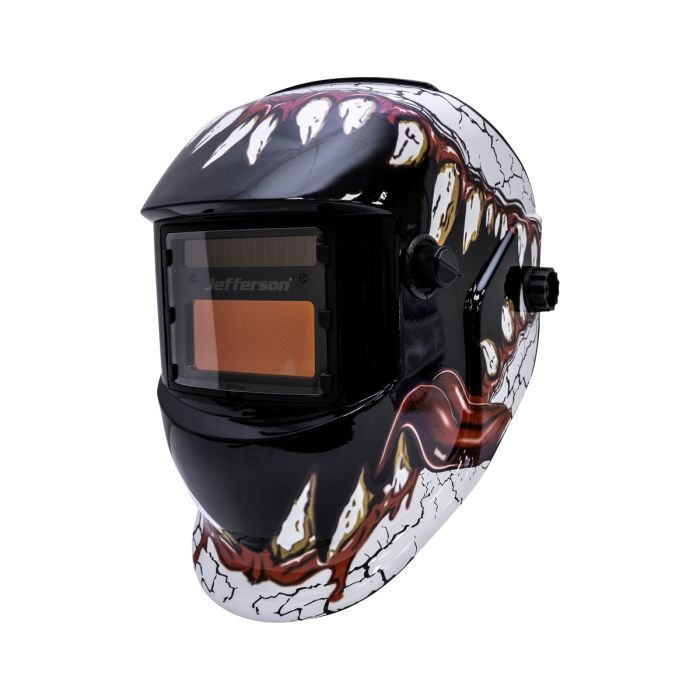 Welding helmet with a colorful monster design on a white background