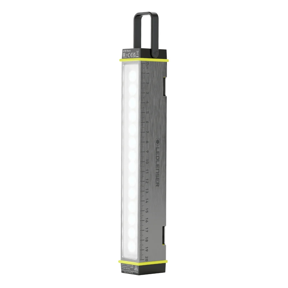 Small rectangular light with a ruler on a white background