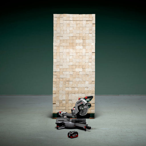 Metabo KGS 18 LTX BL 216 crosscut mitre saw 614216850 shown in front of a pile of timber to illustrate the number of cuts from one battery.
