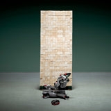 Metabo KGS 18 LTX BL 216 crosscut mitre saw 614216850 shown in front of a pile of timber to illustrate the number of cuts from one battery.
