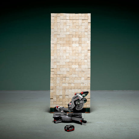 Metabo KGS 18 LTX BL 216 crosscut mitre saw 614216850 shown in front of a pile of timber to illustrate the number of cuts from one battery.
