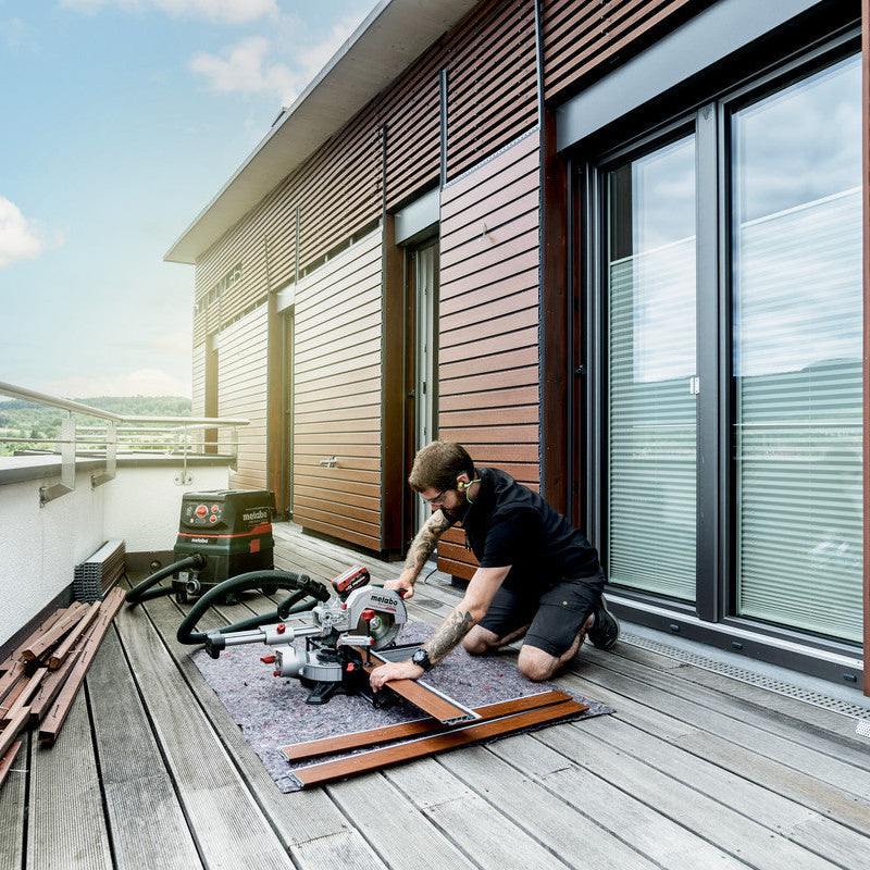 Metabo KGS 18 LTX BL 216 crosscut mitre saw 614216850 shown cutting composite panelling 